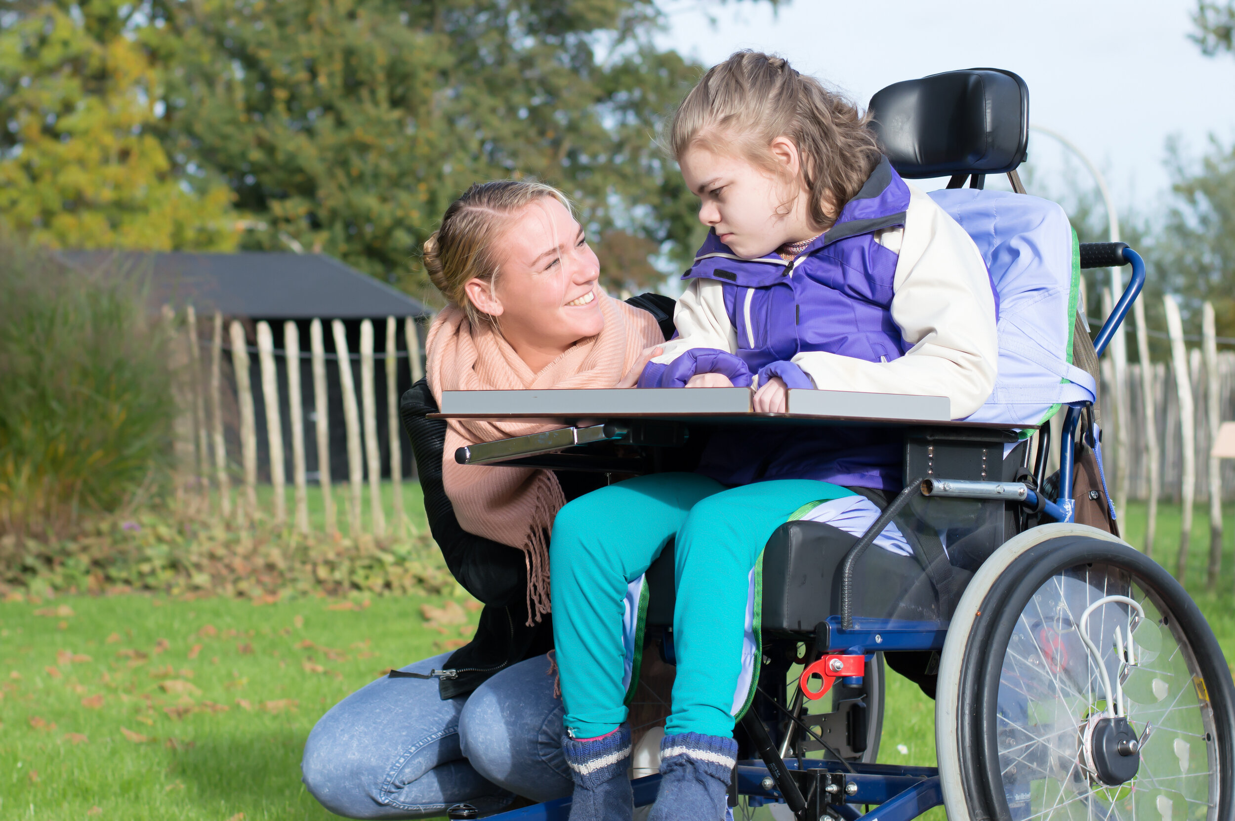 Disability a disabled child in a wheelchair relaxing outside